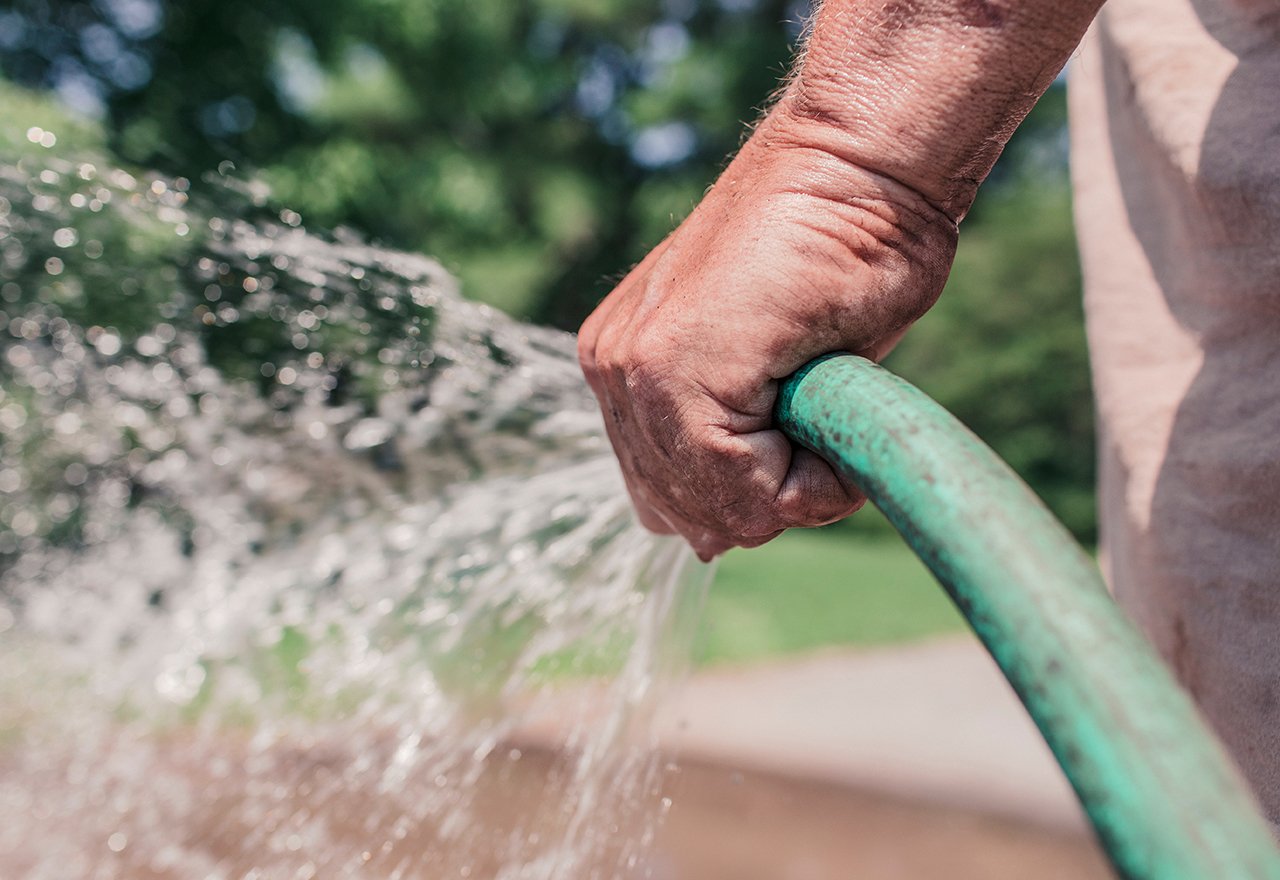 Man Spraying Hose