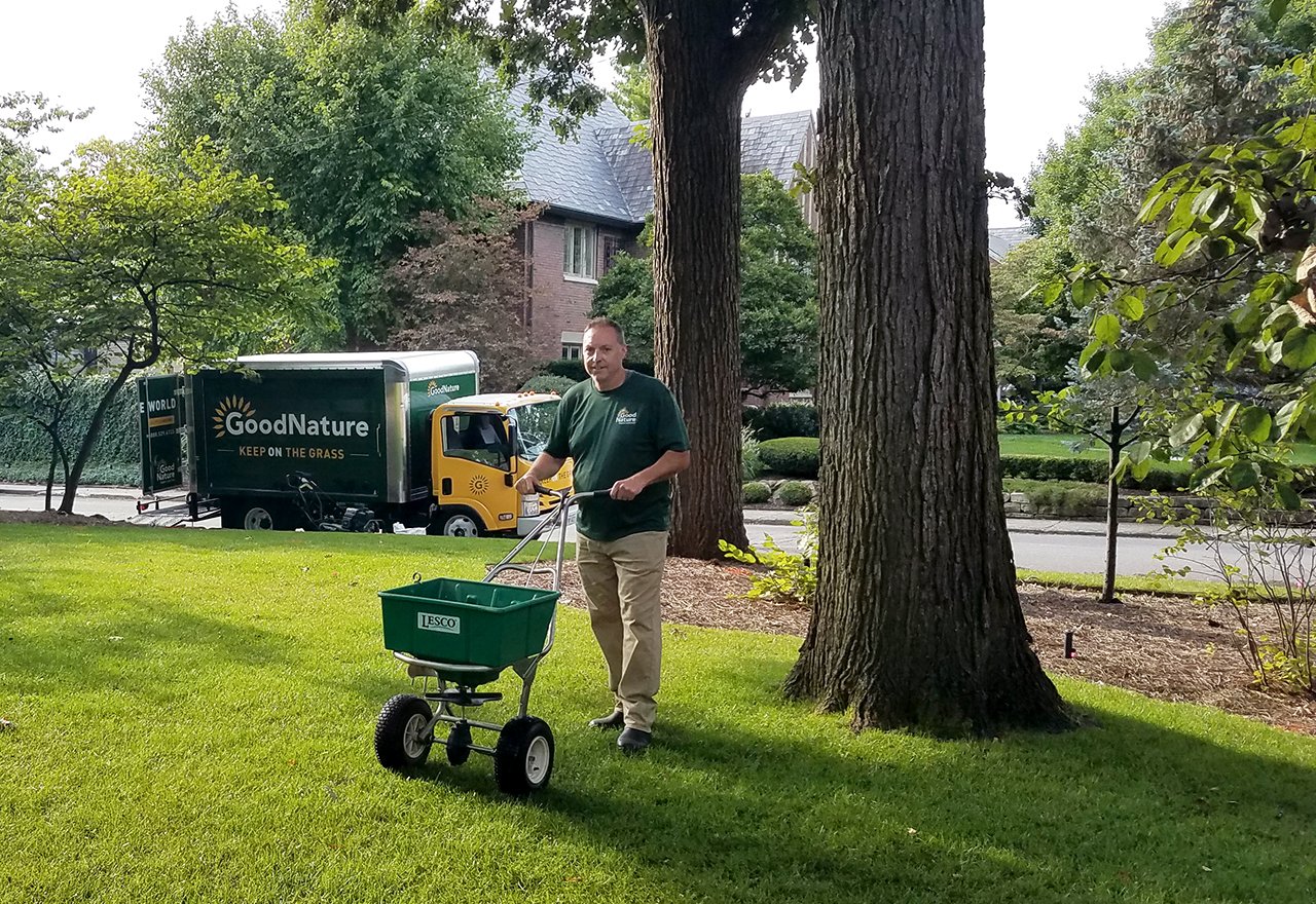 Technician Ed Spreading Seed Lawn