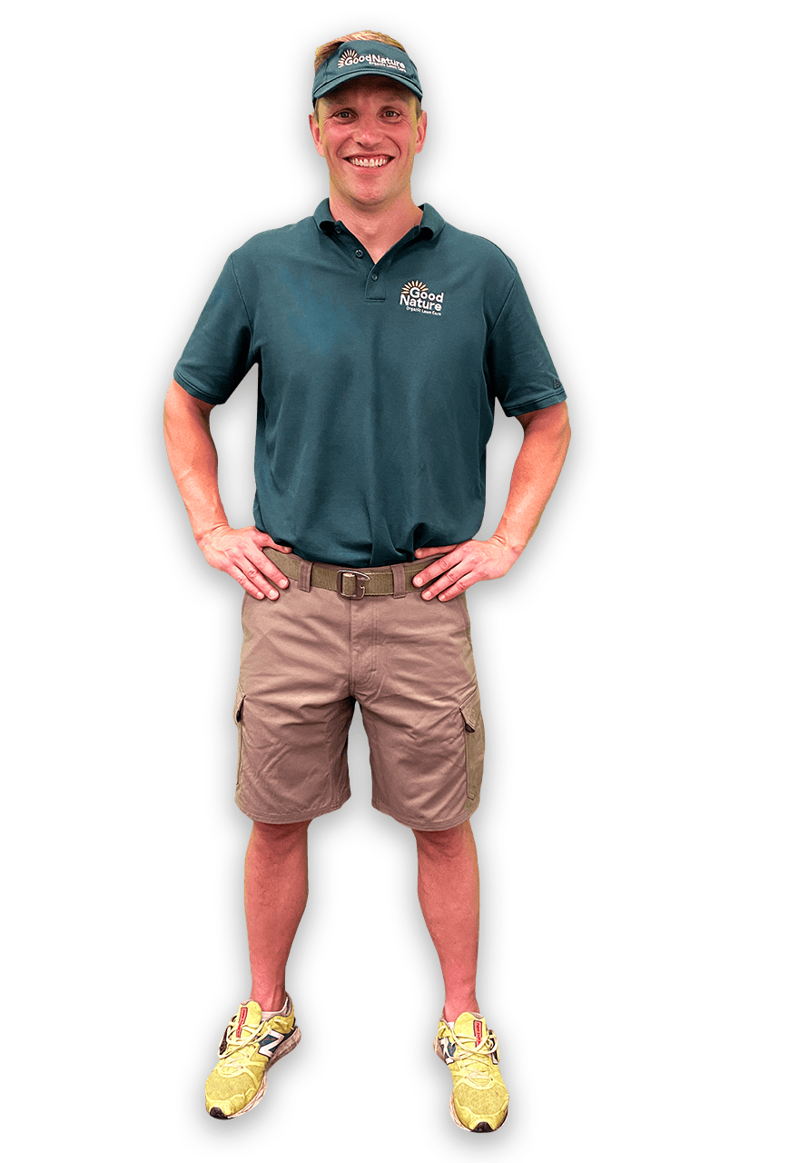 Smiling man standing with hands on hips, wearing Good Nature lawn care uniform and hat Smiling man standing with hands on hips, wearing Good Nature lawn care uniform and hat